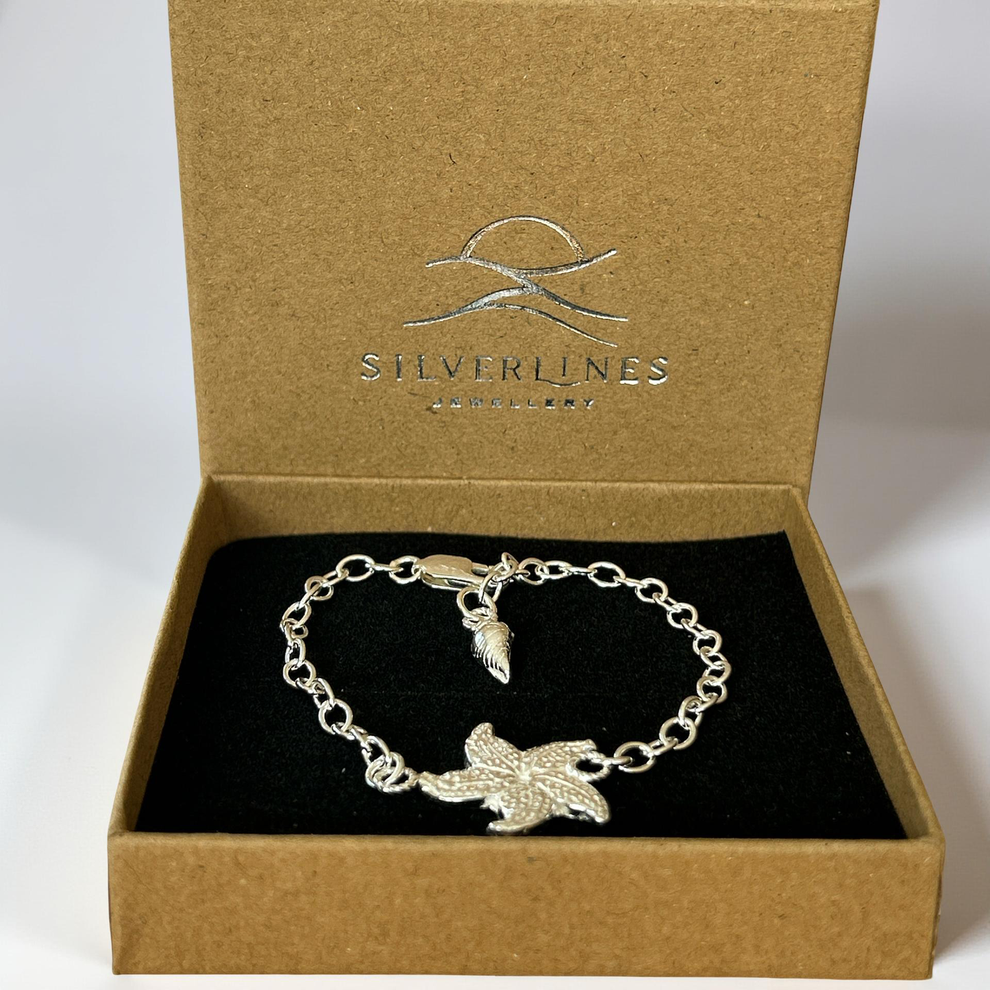 Silver bracelet with a leaf design in a 'Silverlines' jewelry box.